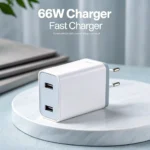 White 66W dual-port fast charger with two USB ports on a marble surface, positioned against a soft-focus background.