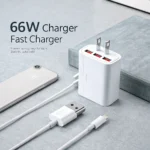 A 66W fast charger with multiple USB ports next to a smartphone on a table, featuring visible power prongs and USB cables.