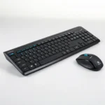 Black wireless keyboard with blue accent keys and matching mouse on a white background.